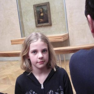 Lara my granddoughter and in the background the Mona Lisa (Louvre)